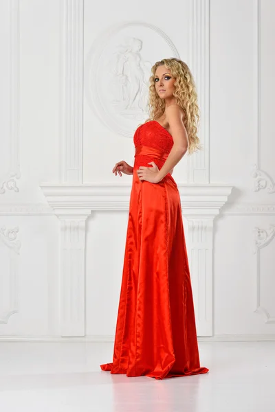 Beautiful woman in red long dress. — Stock Photo, Image