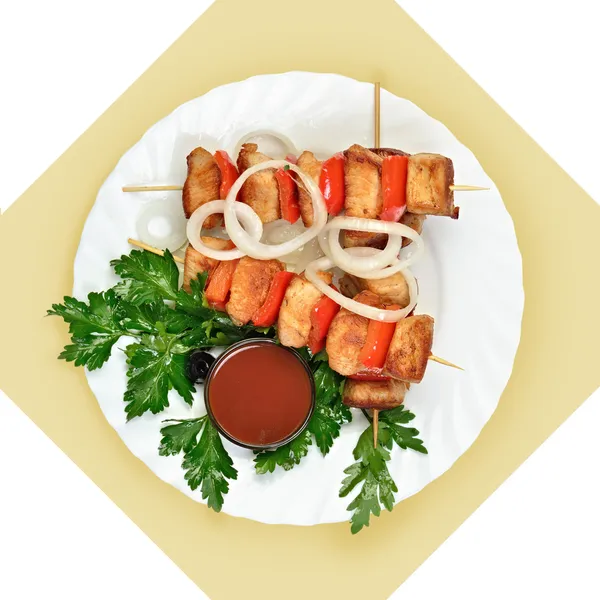 Dish of meat on skewer with tomato sause on white plate. — Stock Photo, Image