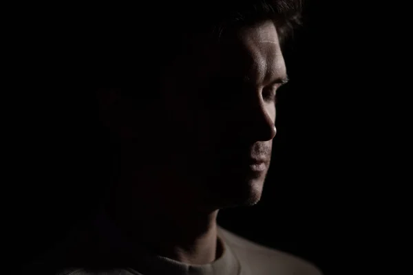 Young thoughtful man with closed eyes in profile, silhouette on black background — Zdjęcie stockowe