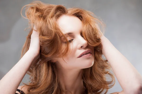 Egy fiatal vörös hajú nő élvezi a haja szépségét., — Stock Fotó