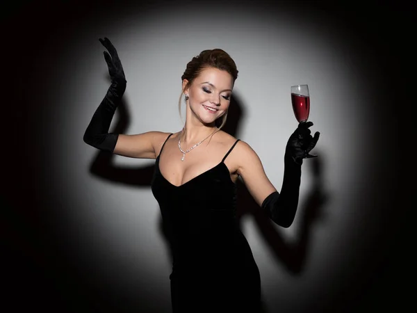 A beautiful woman in a black dress with a neckline and long velvet gloves, Fotos De Bancos De Imagens