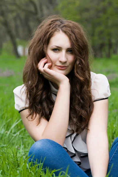 Girl sitting in the grass Royalty Free Stock Images