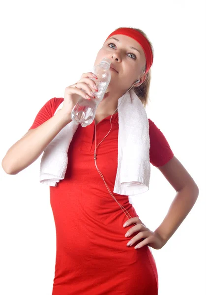 Sporty woman with water, towel and headphones — Stock Photo, Image