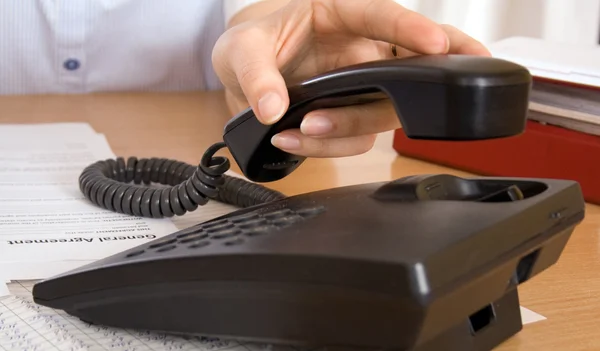 Hand reaching for telephone — Stock Photo, Image