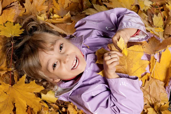 Girl with yellow foliage — Stock Photo, Image