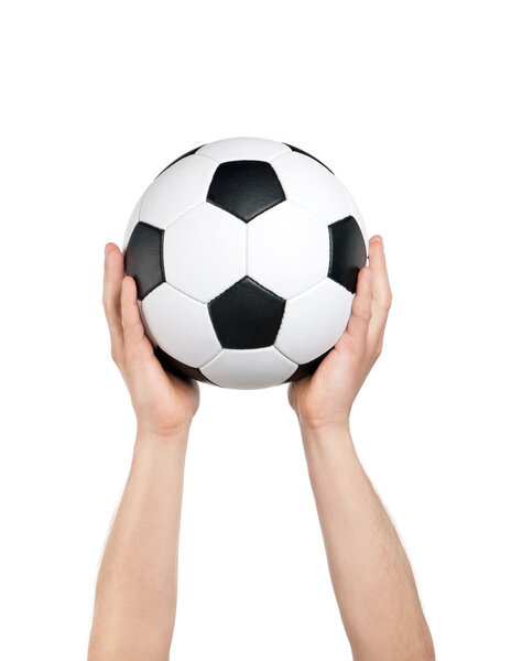 Classic soccer ball in hands of man on isolated white background