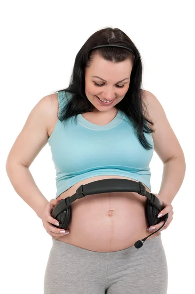Ciąży brzuch ze słuchawkami — Zdjęcie stockowe