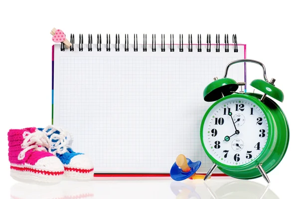 Blank card with baby shoes and alarm clock — Stock Photo, Image