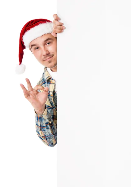 Jonge man in Kerstman hoed — Stockfoto