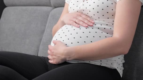 Pregnant Woman Holding Eating Red Apple While Sitting Sofa Home — Video