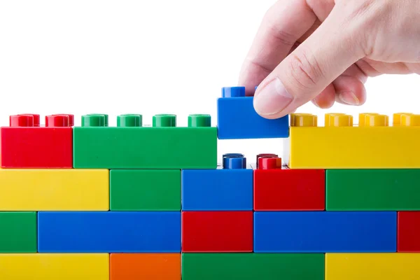 Hand building up a block — Stock Photo, Image