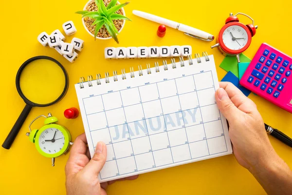 Hand Holding Planner Showing Month January Flatlay — Stock Photo, Image