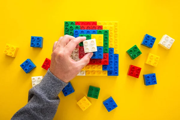 Hand Stacking Colorful Plastic Block — Stock Photo, Image