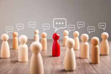 Mingle, discussion, chatting concept. Wooden figurine with speech bubble