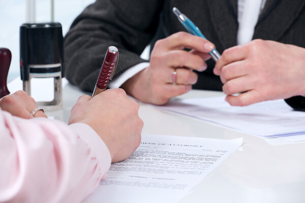Hands of the woman signature document