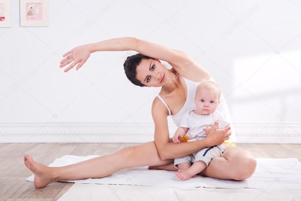 Healthy mother and baby making gymnastics