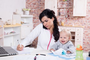 Mother and baby in home office clipart