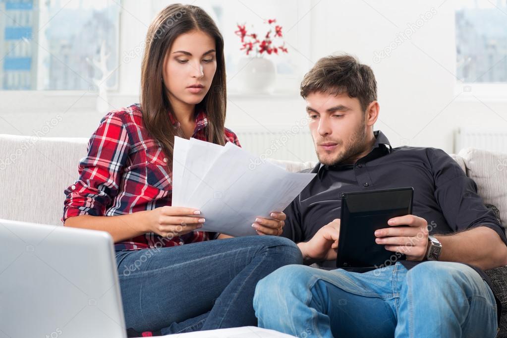 Couple calculating their domestic bills at home