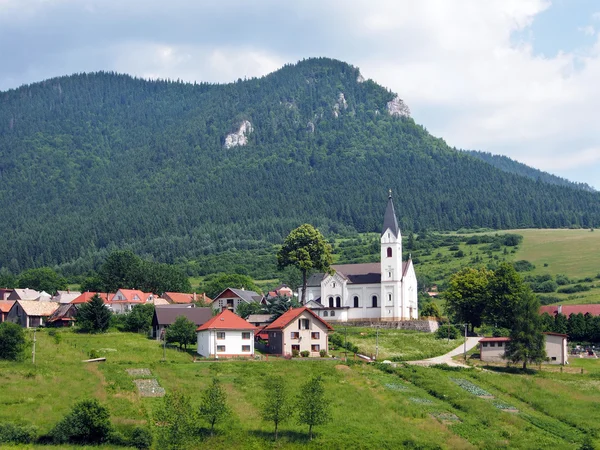 Church and hill in Valaská Dubová — Stock Fotó