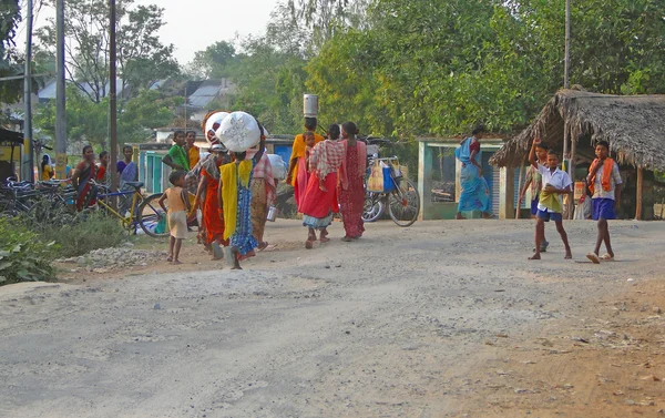 Local village women carry pots on their heads