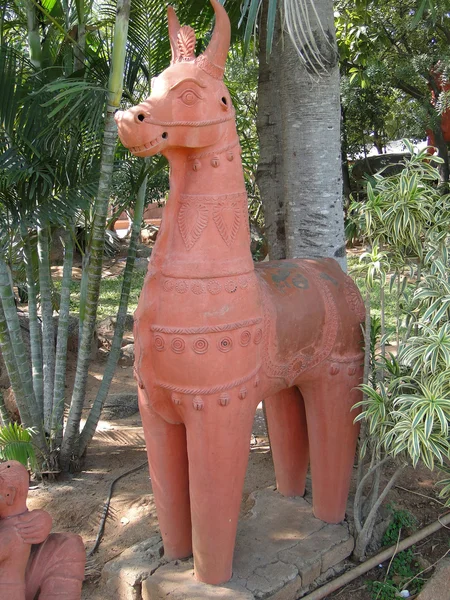 Terra cotta horses in folk art garden