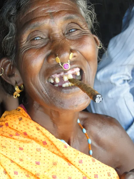 Old woman smokes a cheroot