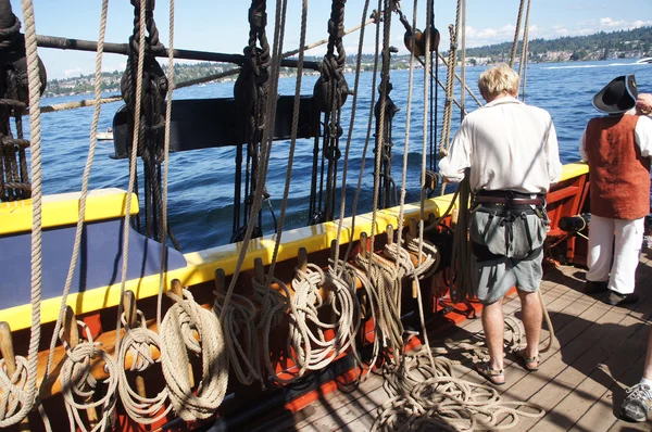 The crew sets the sails of the Lady Washington