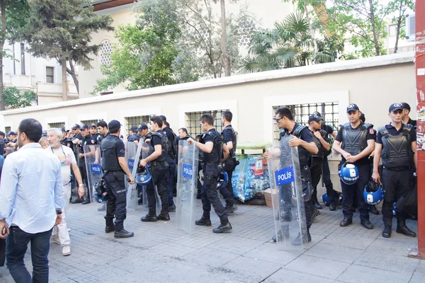 Police in riot gear await orders during a protest
