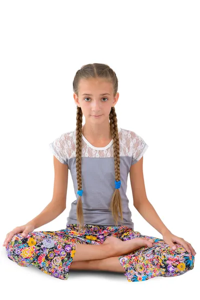 Girl sitting in the lotus position Royalty Free Stock Images