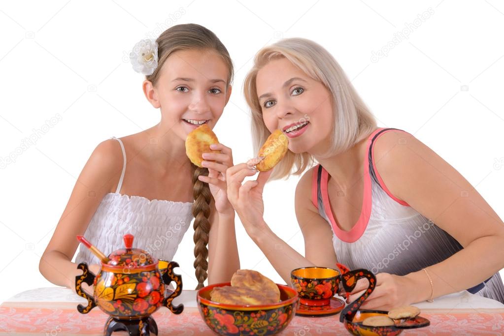 Mother and daughter eating pies