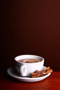 Cup hot Tea on brown background clipart
