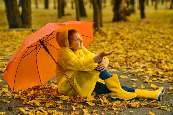 Little Girl Sitting Asphalt Orange Umbrella Rain Autumn Outdoor Fun — Stock Photo, Image