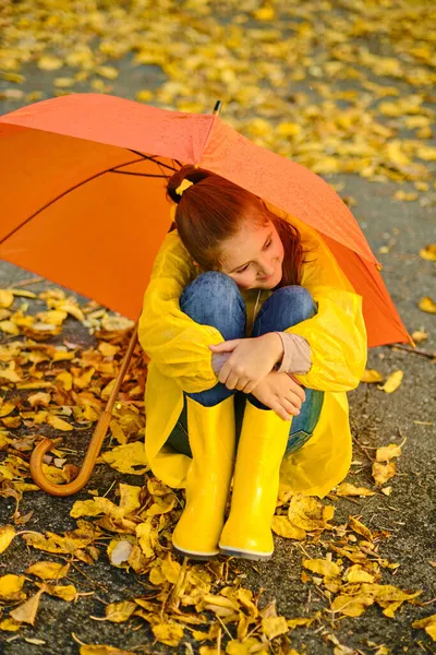 Little Girl Sitting Asphalt Orange Umbrella Rain Autumn Outdoor Fun — Stock Photo, Image