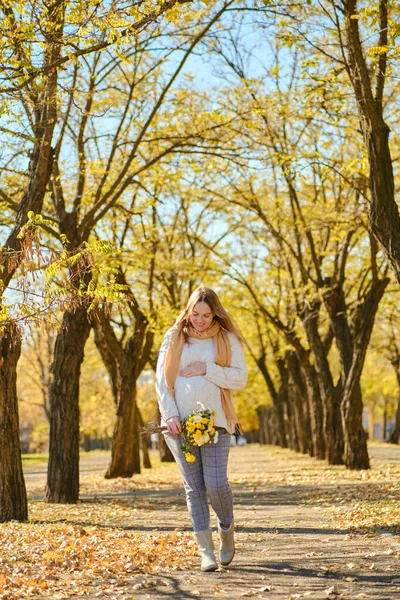 Attractive Millennial Pregnant Woman Flowers Holding Her Tummy Autumn Park — Stock Photo, Image