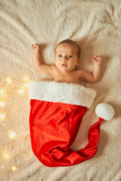 Little Newborn Baby Big Red Santa Hat Blanket Lights Garland — Stock Photo, Image