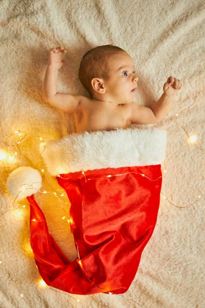 Little Newborn Baby Big Red Santa Hat Blanket Lights Garland — Stock Photo, Image