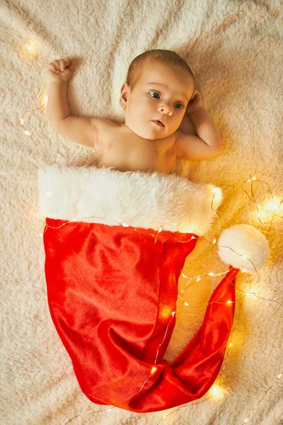 Little Newborn Baby Big Red Santa Hat Blanket Lights Garland — Stock Photo, Image