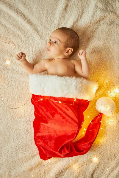 Little Newborn Baby Big Red Santa Hat Blanket Lights Garland — Stock Photo, Image