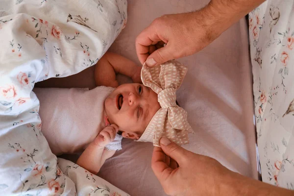 Hands Caring Father Put Newborn Baby Lying Baby Bed Bow — Photo