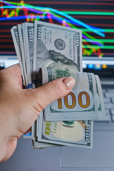 Dollars bills and woman hand against the background of screen — Stock Photo, Image