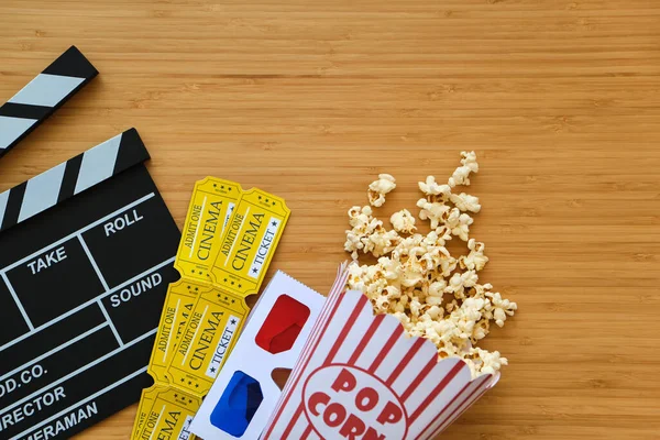 clapper board, movies tickets and popcorn. Movie top view on red background with copy space