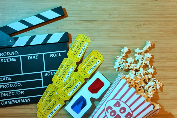 clapper board, movies tickets and popcorn. Movie top view on red background with copy space