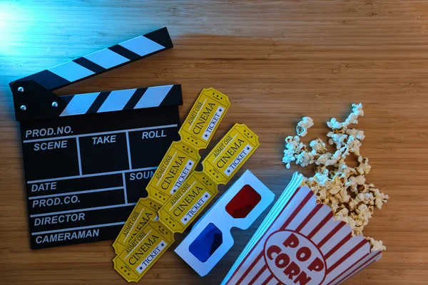 clapper board, movies tickets and popcorn. Movie top view on red background with copy space