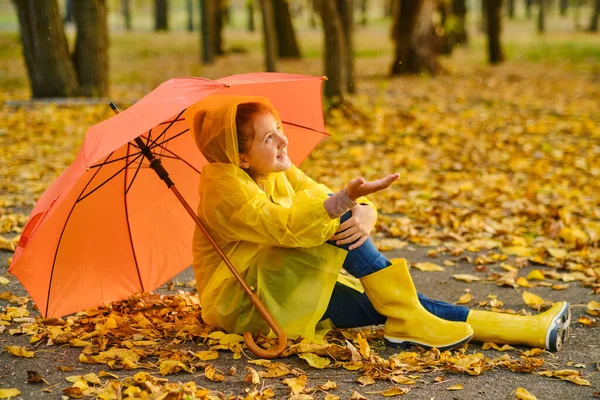 Happy Kid Sits Orange Umbrella Autumn Park Catching Rain Drops — Stock Photo, Image