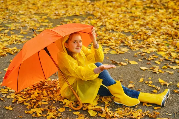 Happy Kid Sits Orange Umbrella Autumn Park Catching Rain Drops — Stock Photo, Image