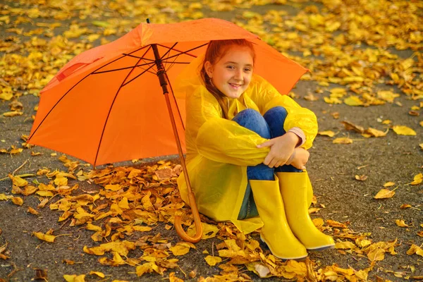 Happy Kid Sits Orange Umbrella Autumn Park — Stock Photo, Image