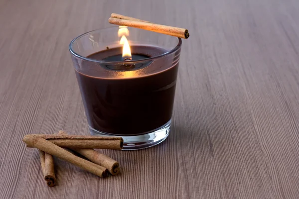 Candle in the Glass and Cinnamon — Stock Photo, Image