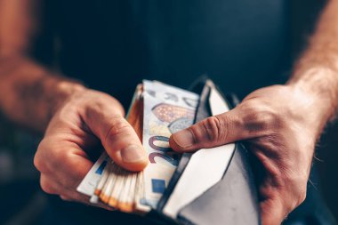 Bir cüzdanda para yığını - satın alma gücü - erkek elleri yakın çekim