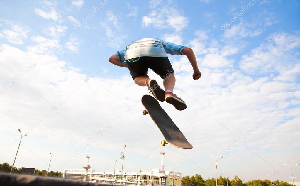 skateboarder over city