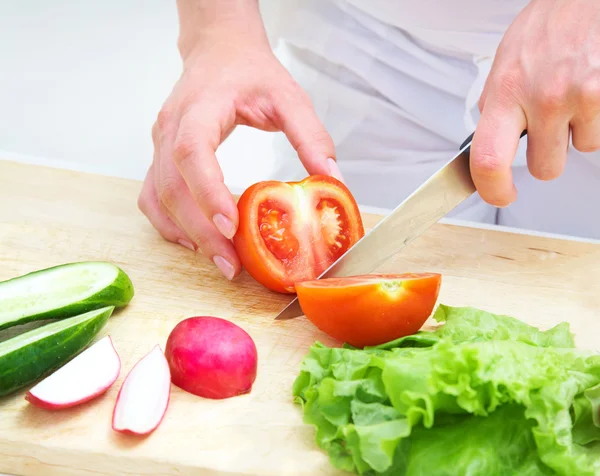 Hands cooking vegetables salad Royalty Free Stock Photos